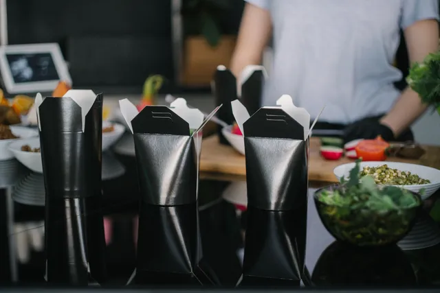 Takeout containers lined up on the counter ready for pickup